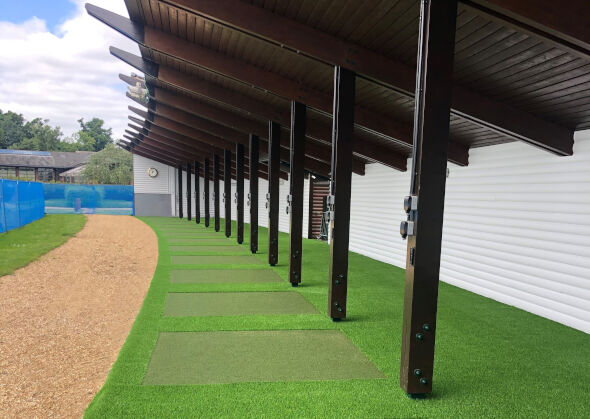 Los Angeles and Southern California Covered outdoor tee line with light green synthetic grass boxes inside a dark green synthetic grass strip